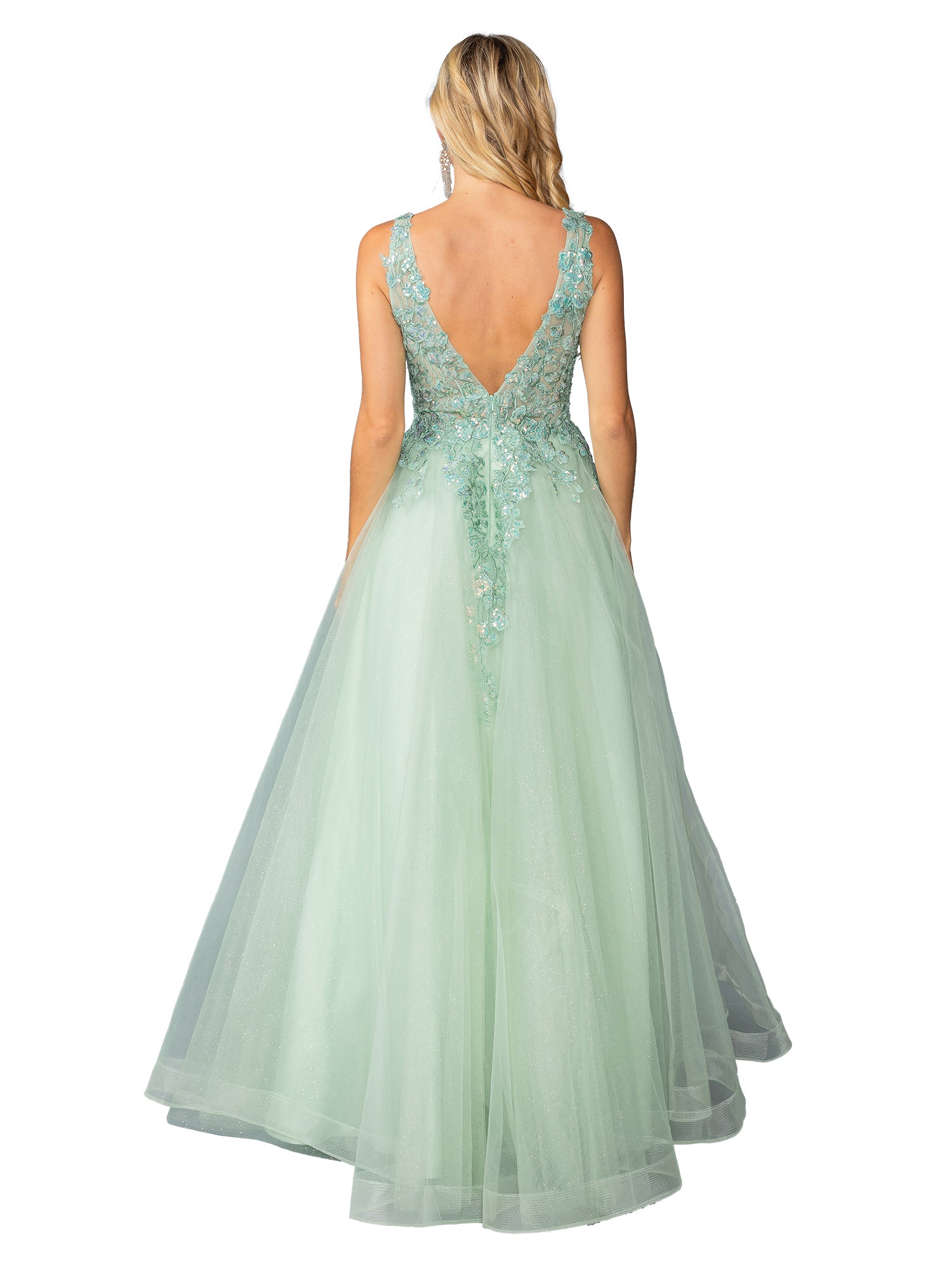 A blonde woman stands with her back to the camera, wearing the Dancing Queen 4430 pastel long prom ball gown—an A-line, floor-length dress with a light green hue, deep V-back, and floral lace details.